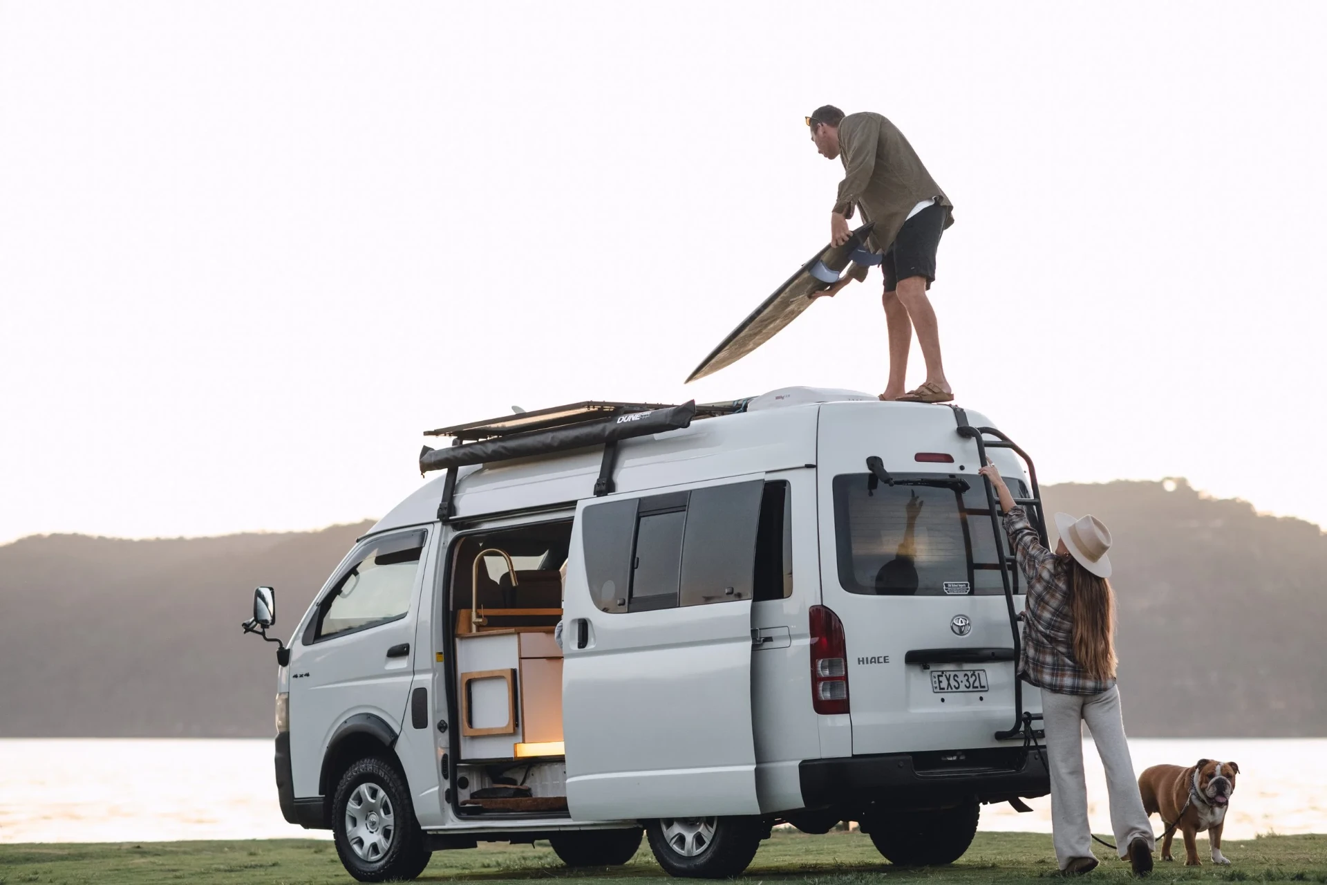 Bulldog Builds rental campervan parked by the water